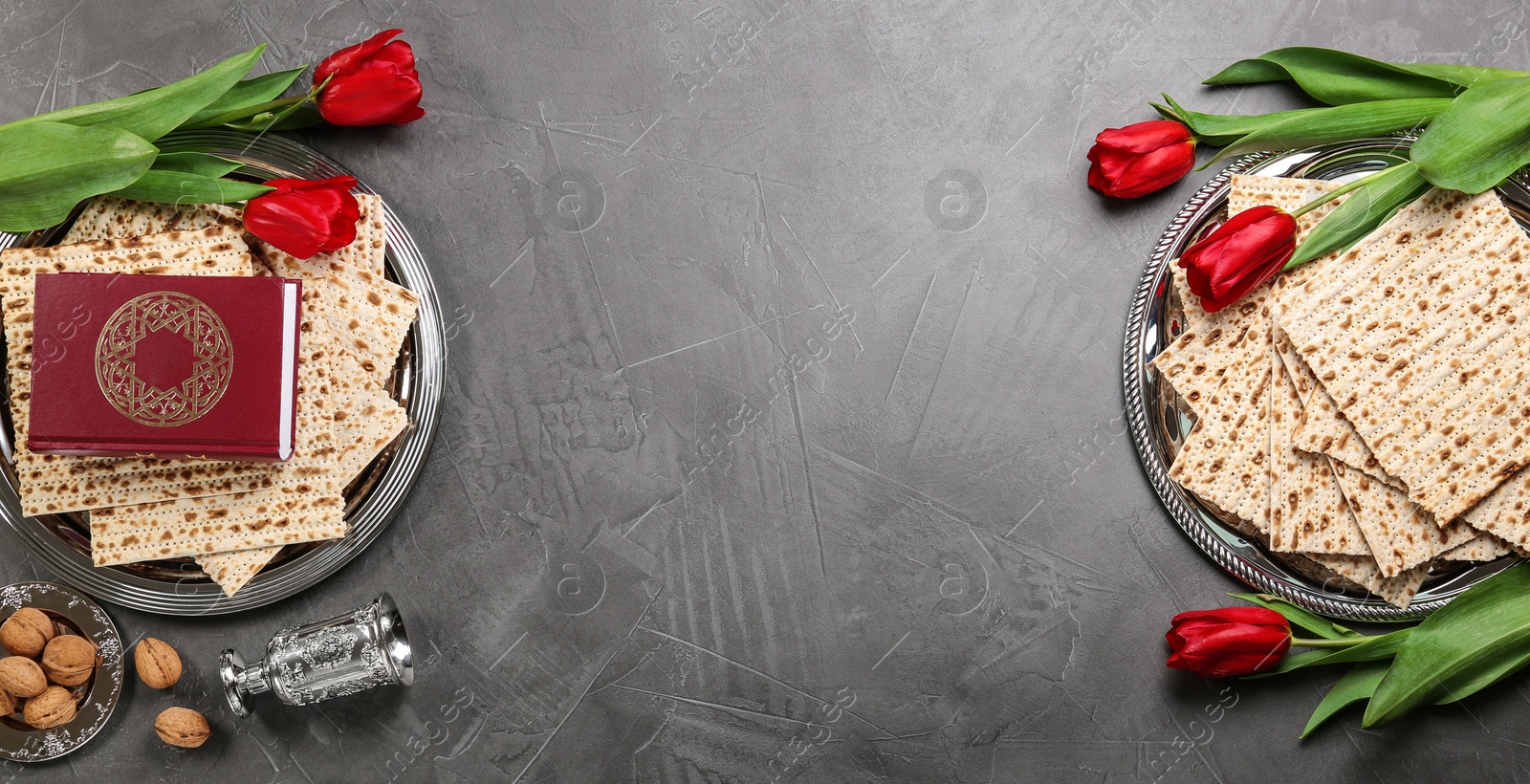 Photo of Flat lay composition with traditional Pesach (Passover Seder) items on grey table. Space for text