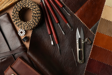 Photo of Flat lay composition with leather samples and tools on  table