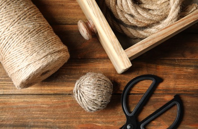 Flat lay composition with natural hemp ropes on wooden background