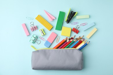 Photo of Flat lay composition with school stationery on light blue background. Back to school
