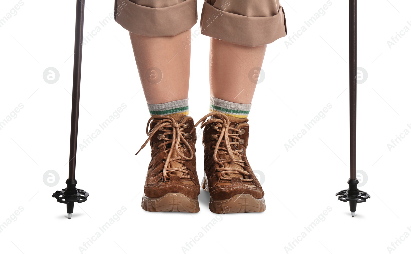 Photo of Woman wearing stylish hiking boots with trekking poles on white background, closeup