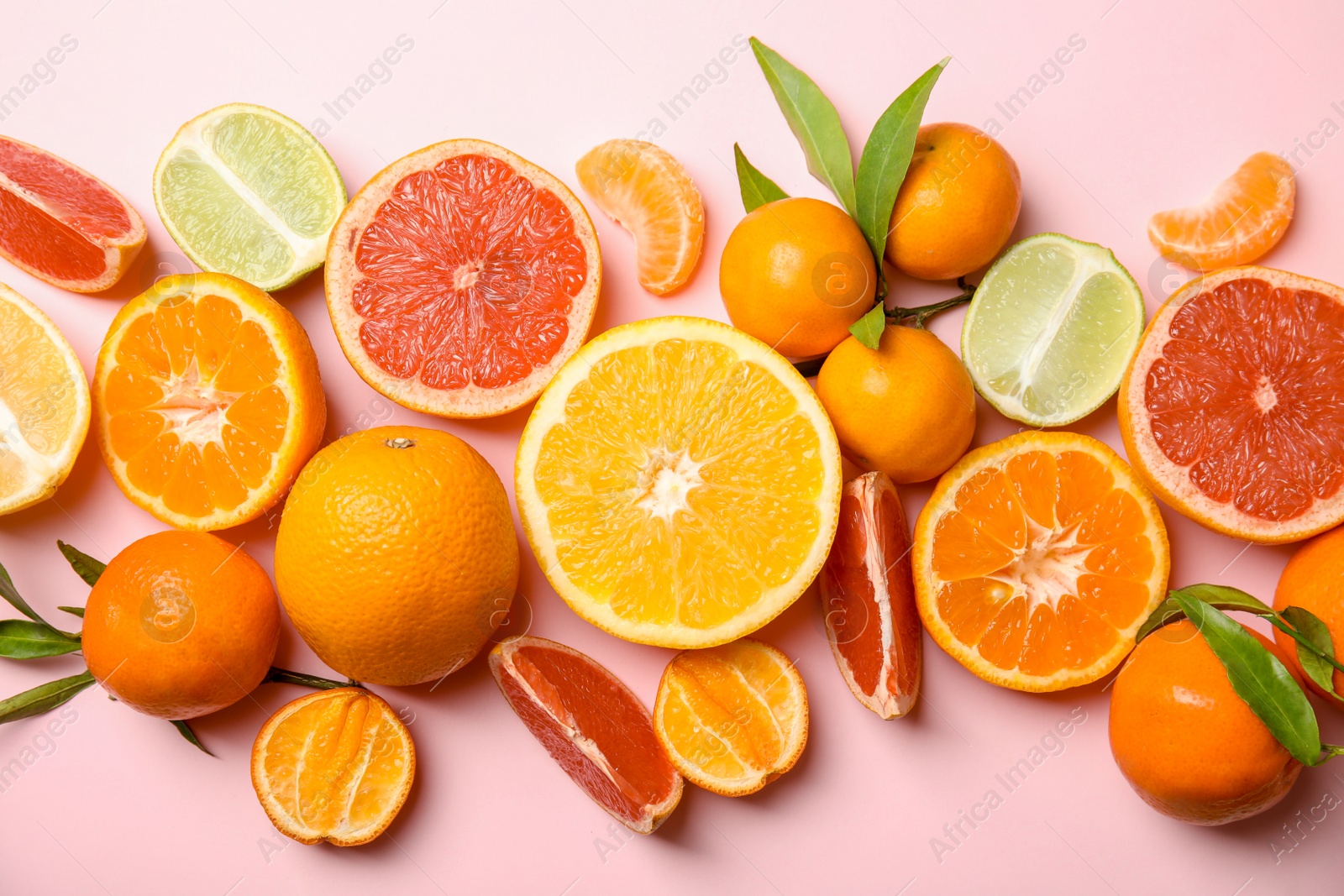 Photo of Different citrus fruits on color background, top view