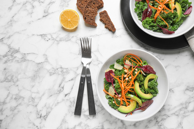 Photo of Tasty fresh kale salad on marble table, flat lay. Space for text