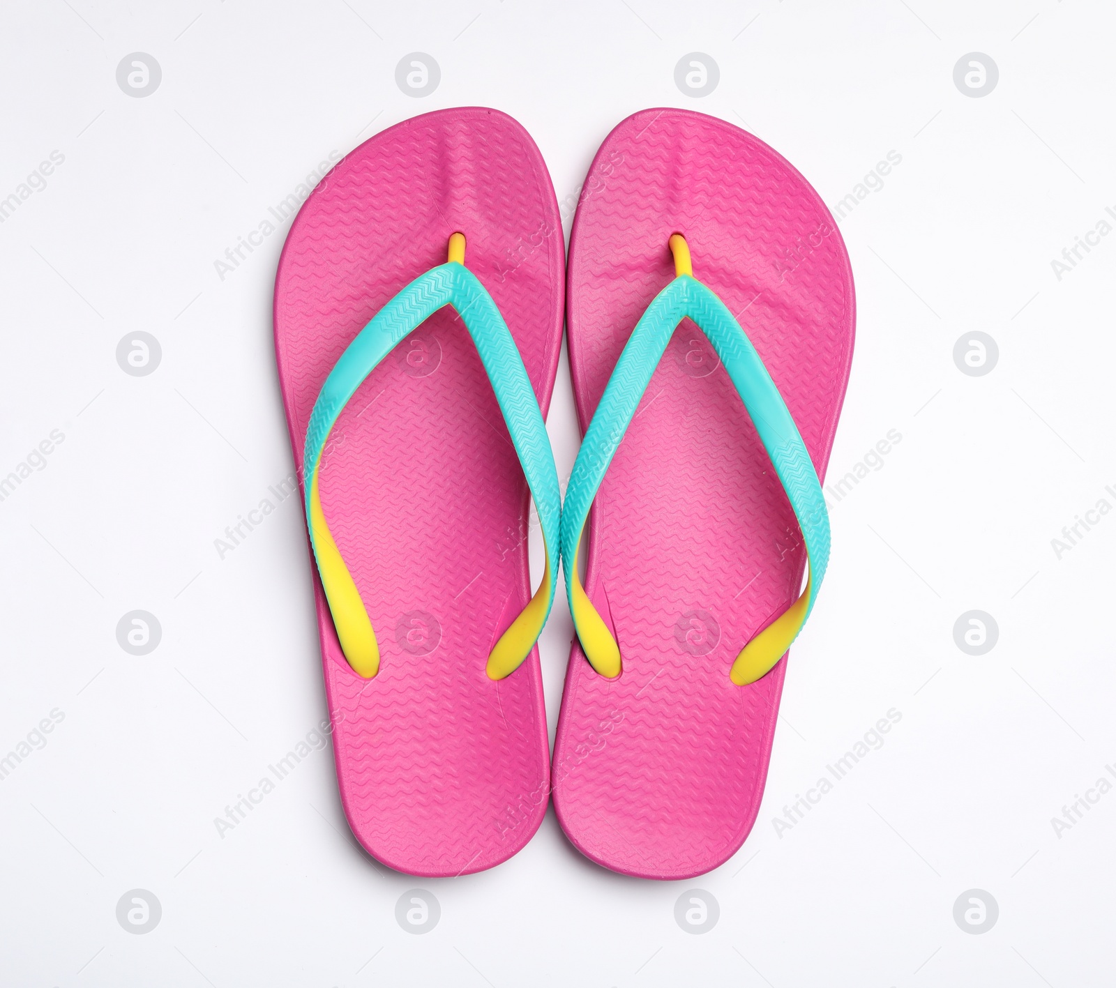 Photo of Pair of flip flops on white background, top view. Beach accessories