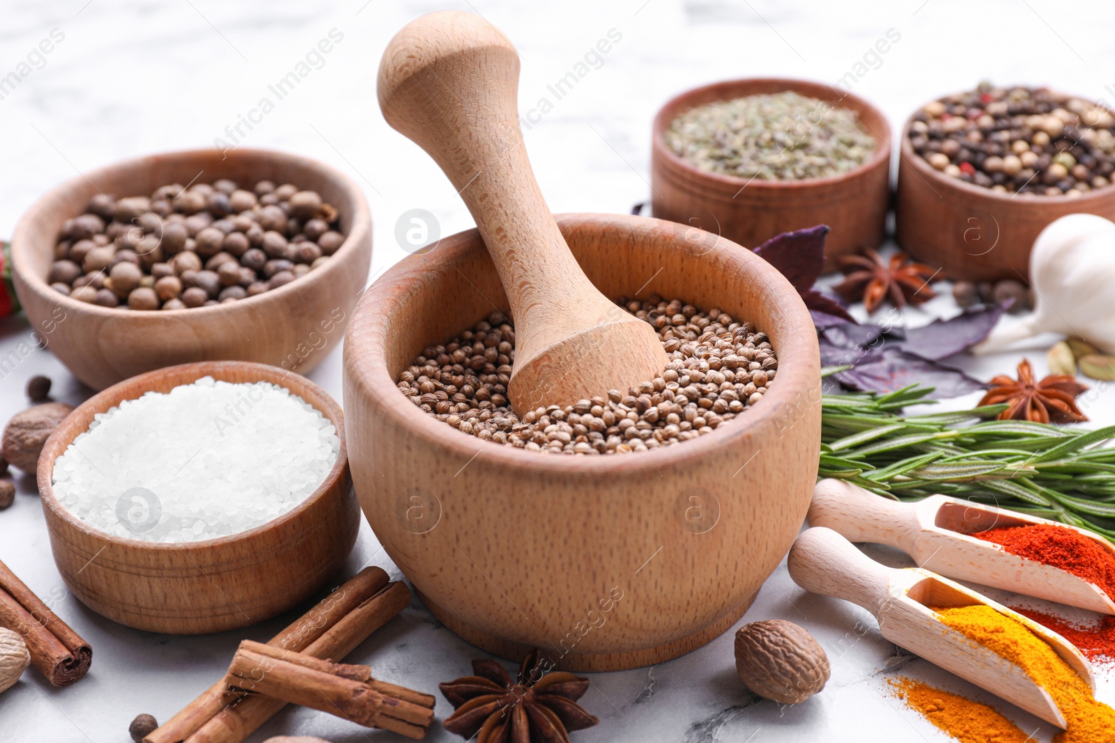 Photo of Mortar and spices on white marble table, closeup