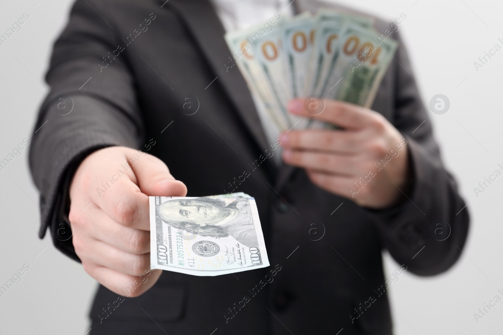 Photo of Man holding money on white background, closeup. Currency exchange