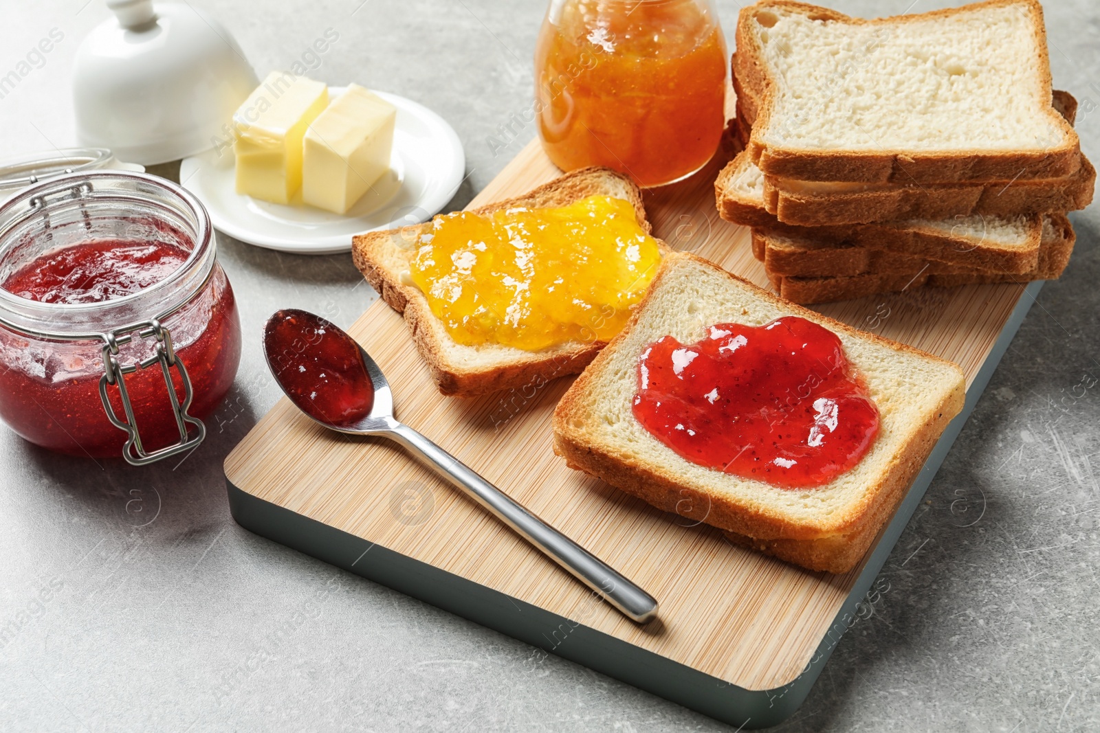 Photo of Toast bread with jams on grey background