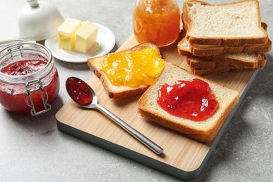 Photo of Toast bread with jams on grey background