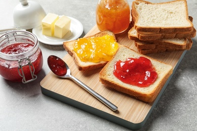 Toast bread with jams on grey background