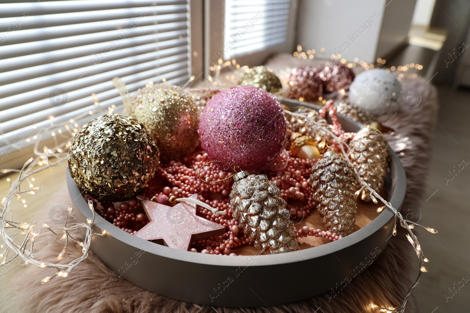 Photo of Beautiful Christmas tree baubles on window sill indoors, closeup