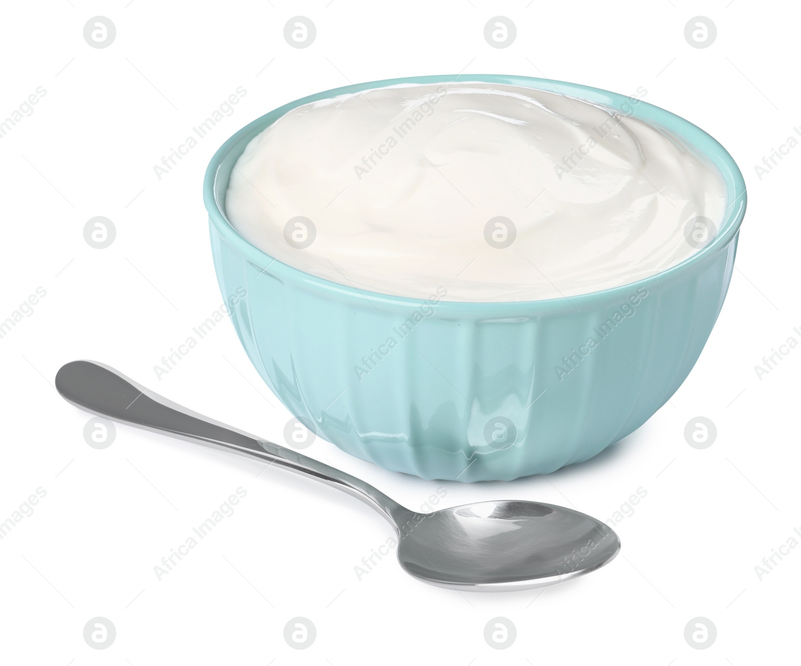 Photo of Bowl with delicious organic yogurt and spoon on white background