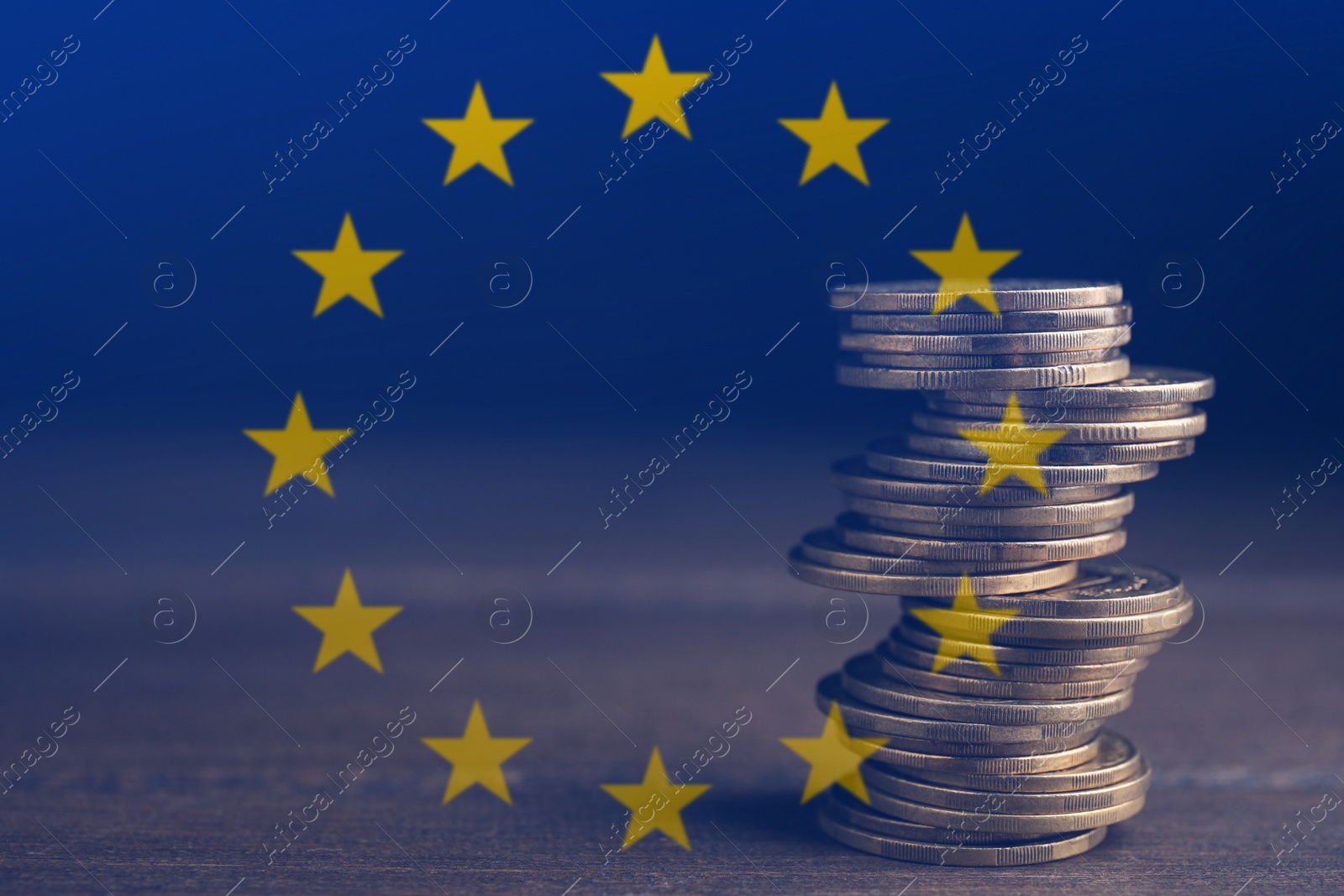 Image of Double exposure of European Union flag and coins on wooden table, closeup view