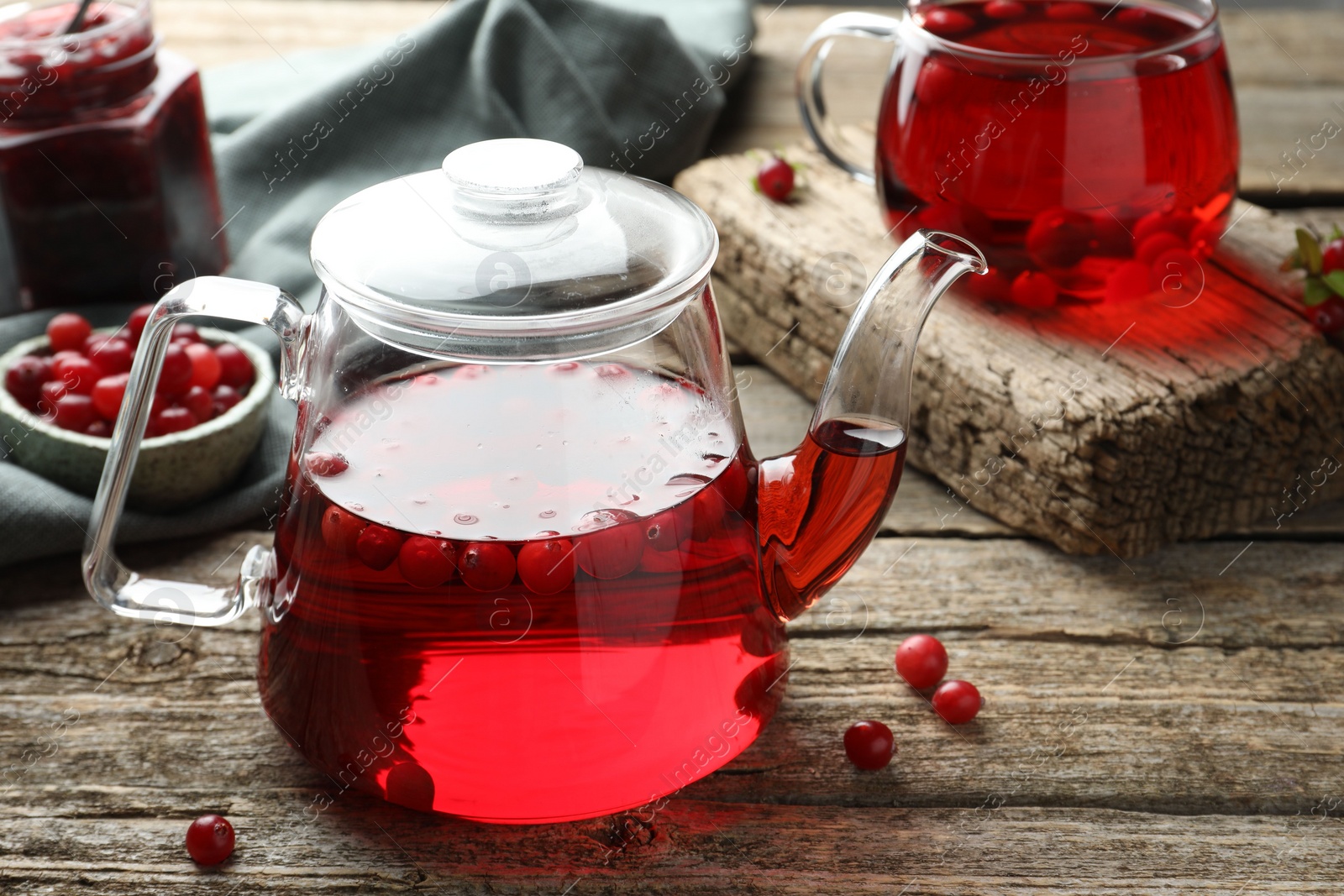 Photo of Delicious cranberry tea and berries on wooden table