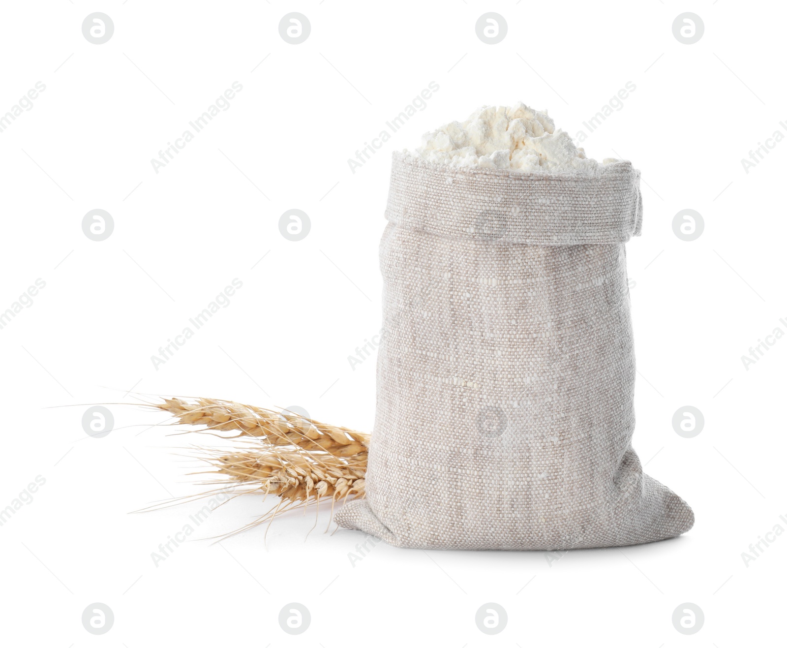 Photo of Sack with flour and wheat spikes on white background