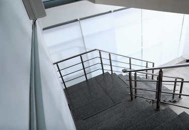 Stone stairs with metal railing indoors, view through CCTV camera