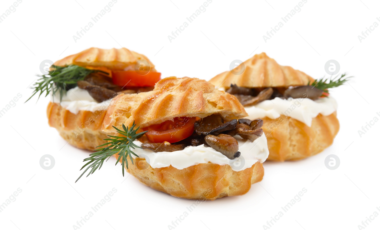 Photo of Delicious profiteroles with cream cheese, mushrooms, tomato and dill isolated on white