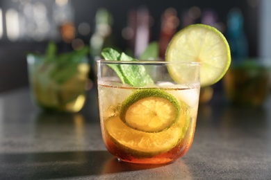 Photo of Glass with delicious mint julep cocktail on bar counter