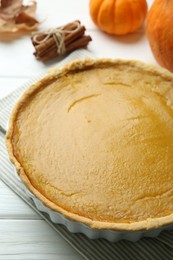 Delicious pumpkin pie on white wooden table