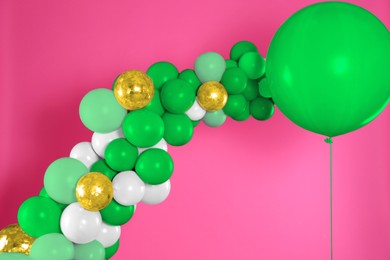 Balloon garland on pink background. Festive decor