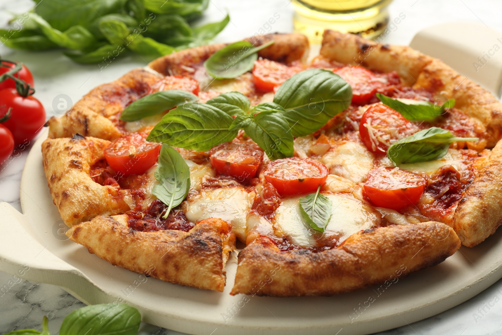 Photo of Delicious Margherita pizza on white marble table, closeup
