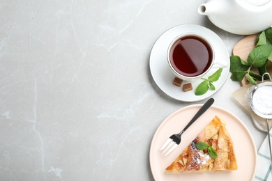 Photo of Slice of traditional apple pie served on light marble table, flat lay. Space for text