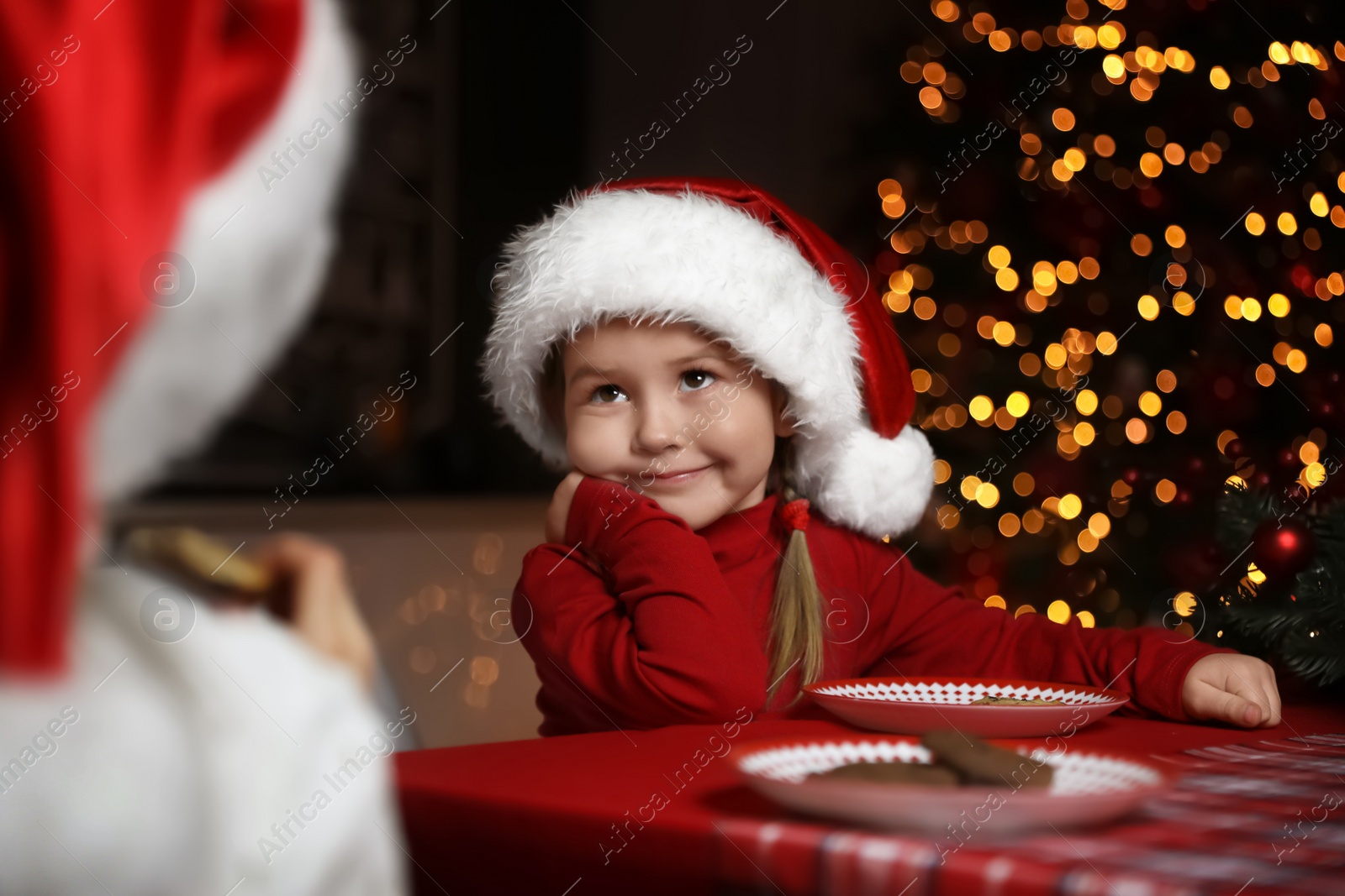 Photo of Cute little children at table in dining room. Christmas time