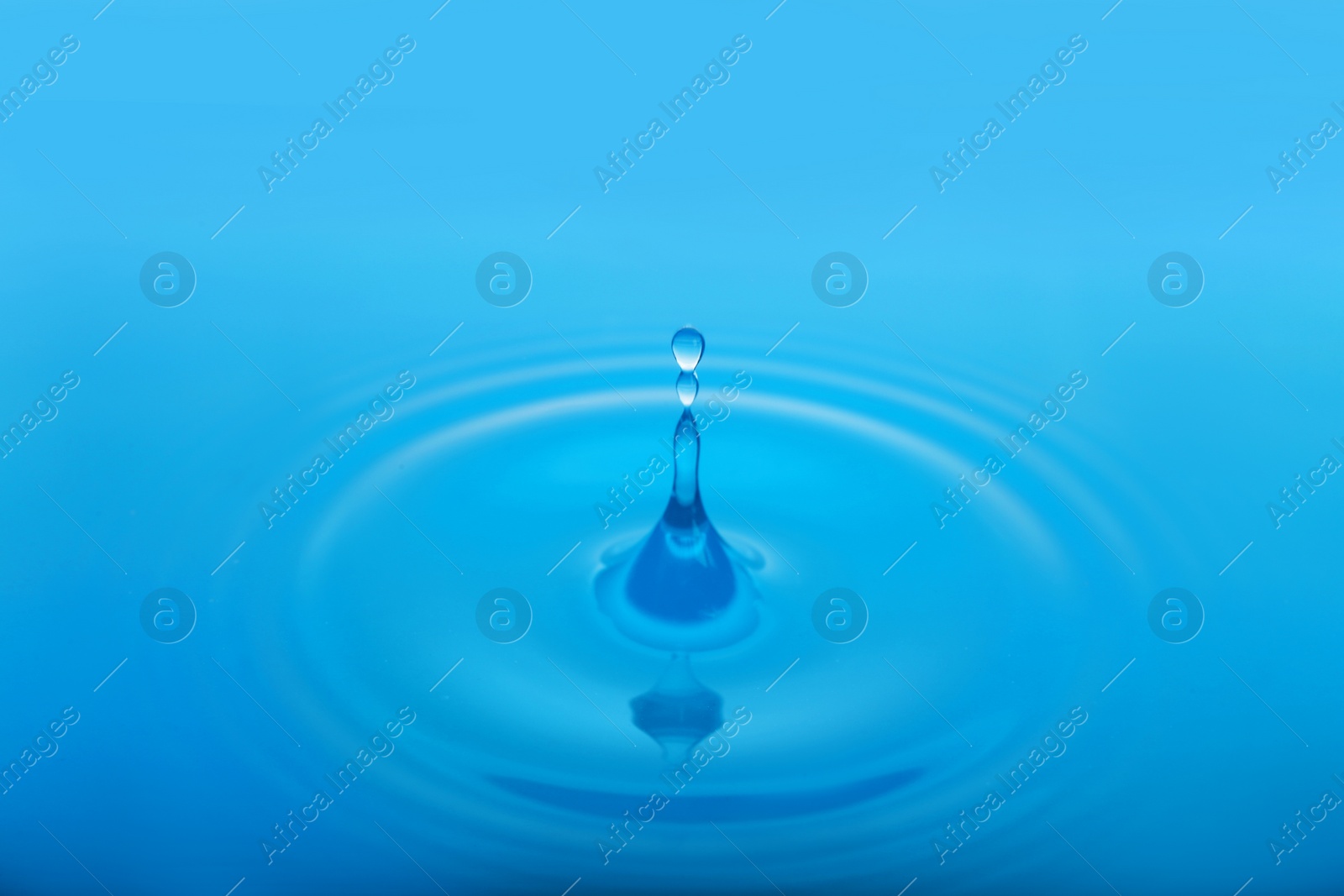 Photo of Splash of blue water with drop as background, closeup