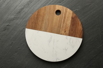 Photo of One new cutting board on dark grey table, top view
