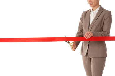 Photo of Woman in office suit cutting red ribbon isolated on white, closeup