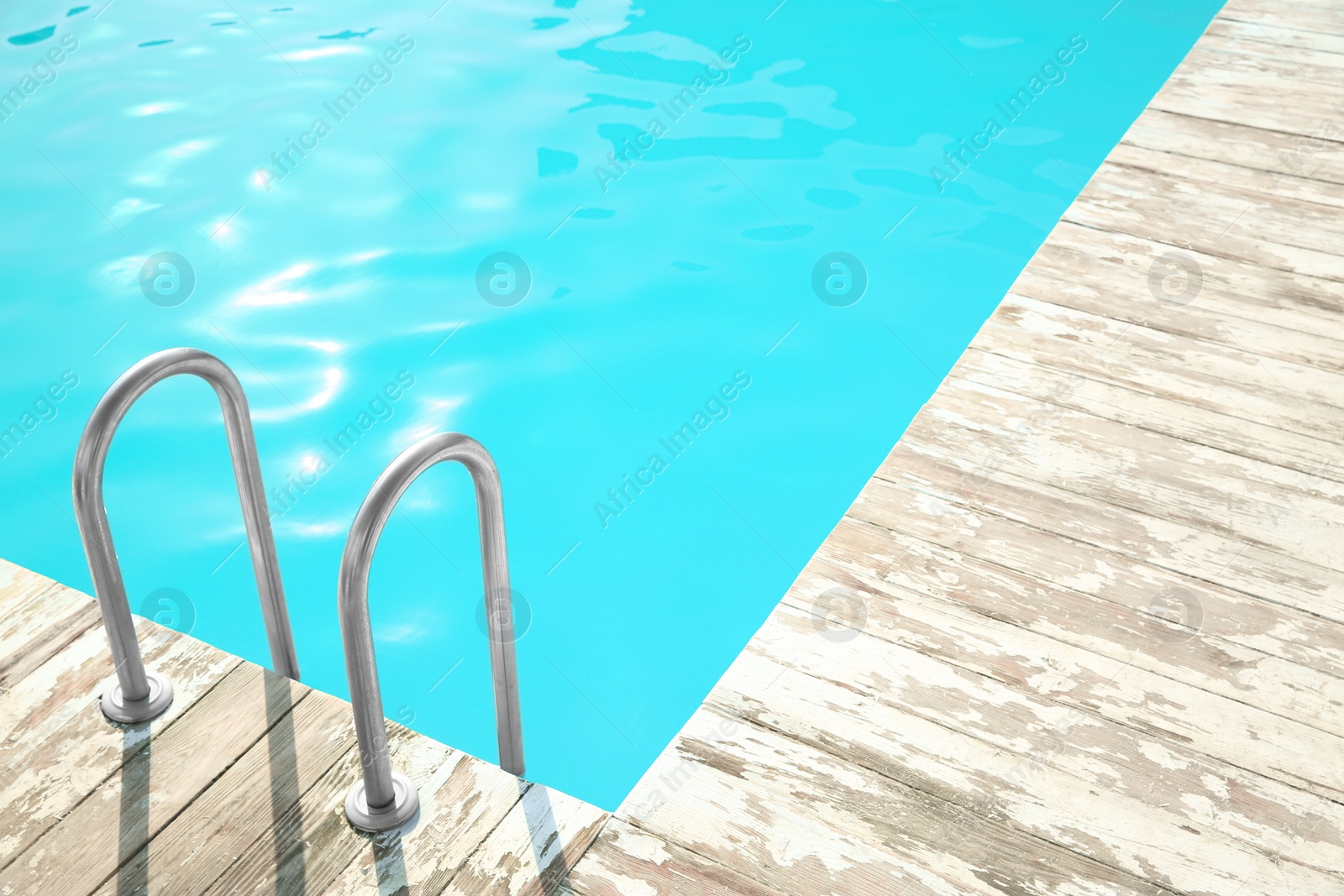 Photo of Ladder with grab bars in outdoor swimming pool