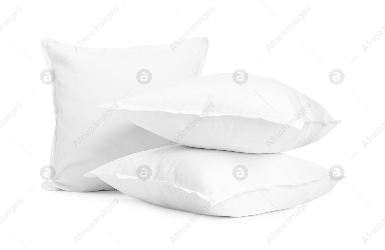 Photo of Three new soft pillows isolated on white