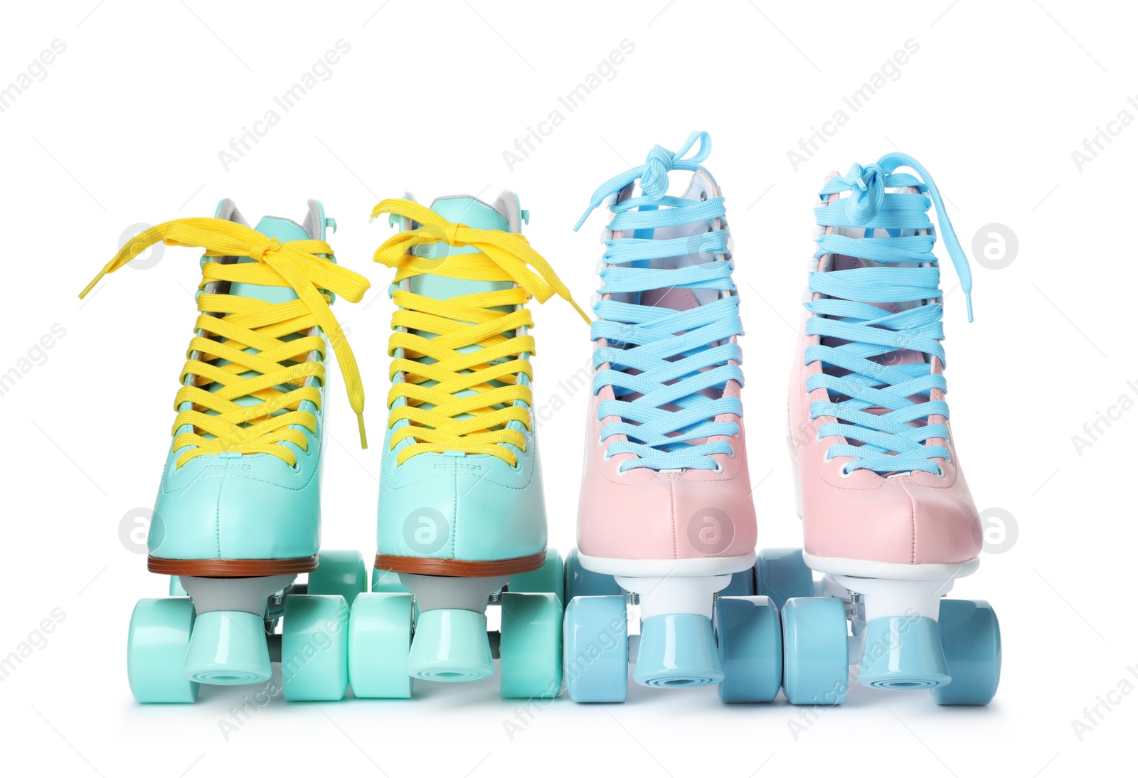 Photo of Pairs of bright stylish roller skates on white background