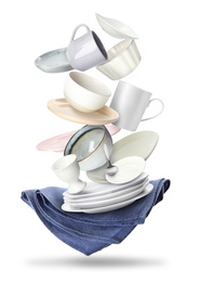 Set of clean tableware and napkin in flight on white background