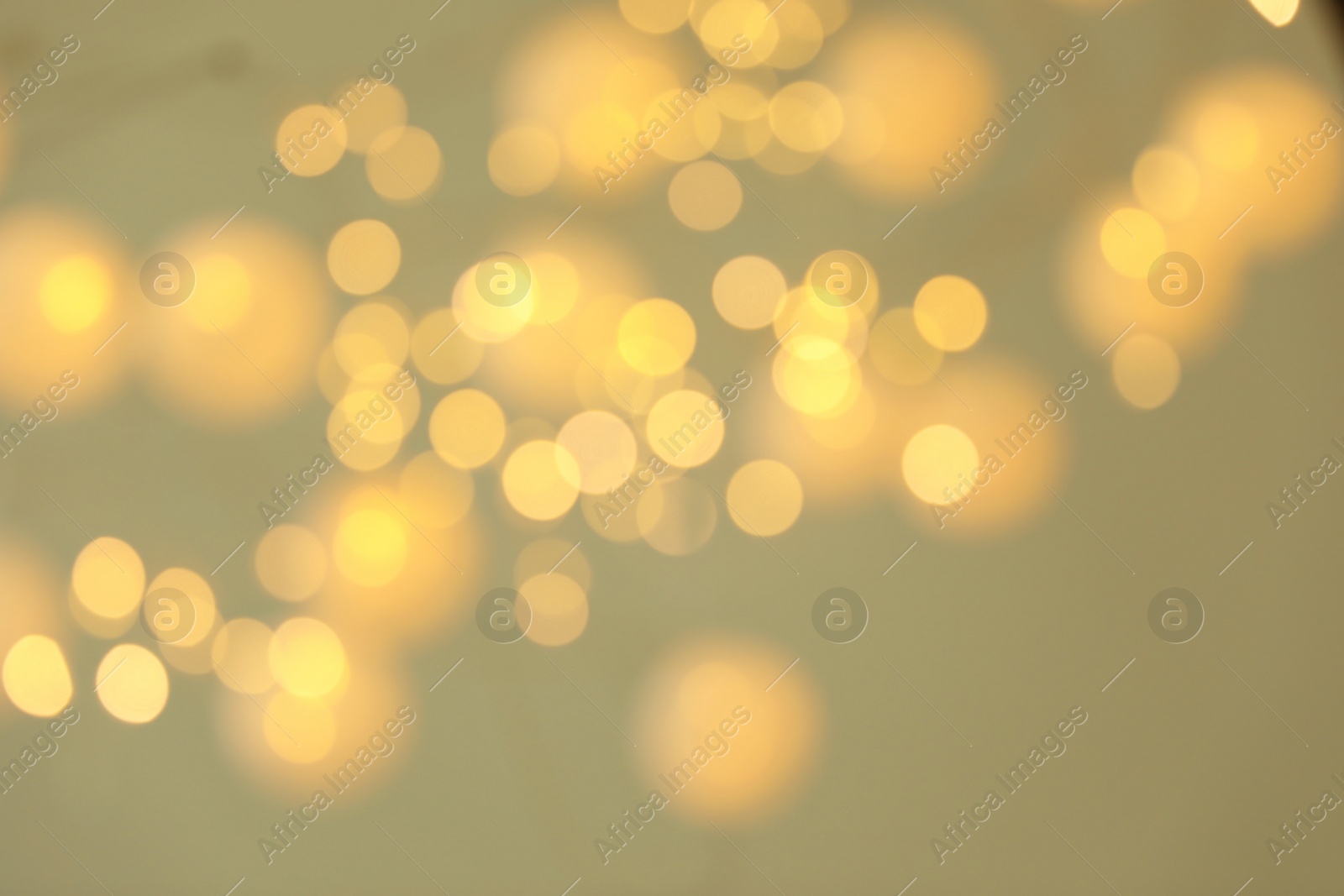 Photo of Blurred view of shiny gold lights. Bokeh effect