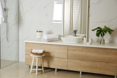 Large mirror and vessel sink in stylish bathroom