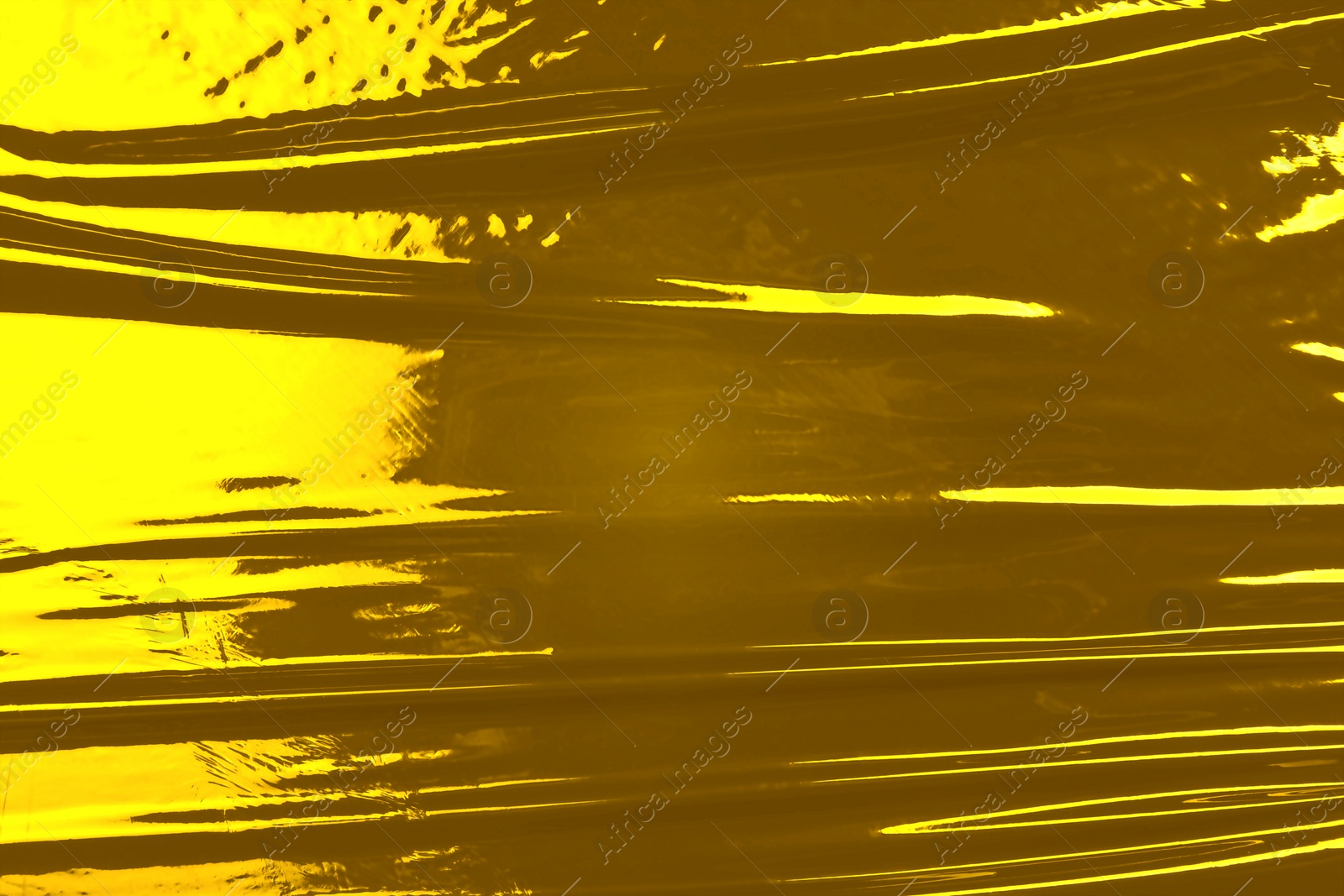 Image of Golden plastic stretch wrap film as background, top view