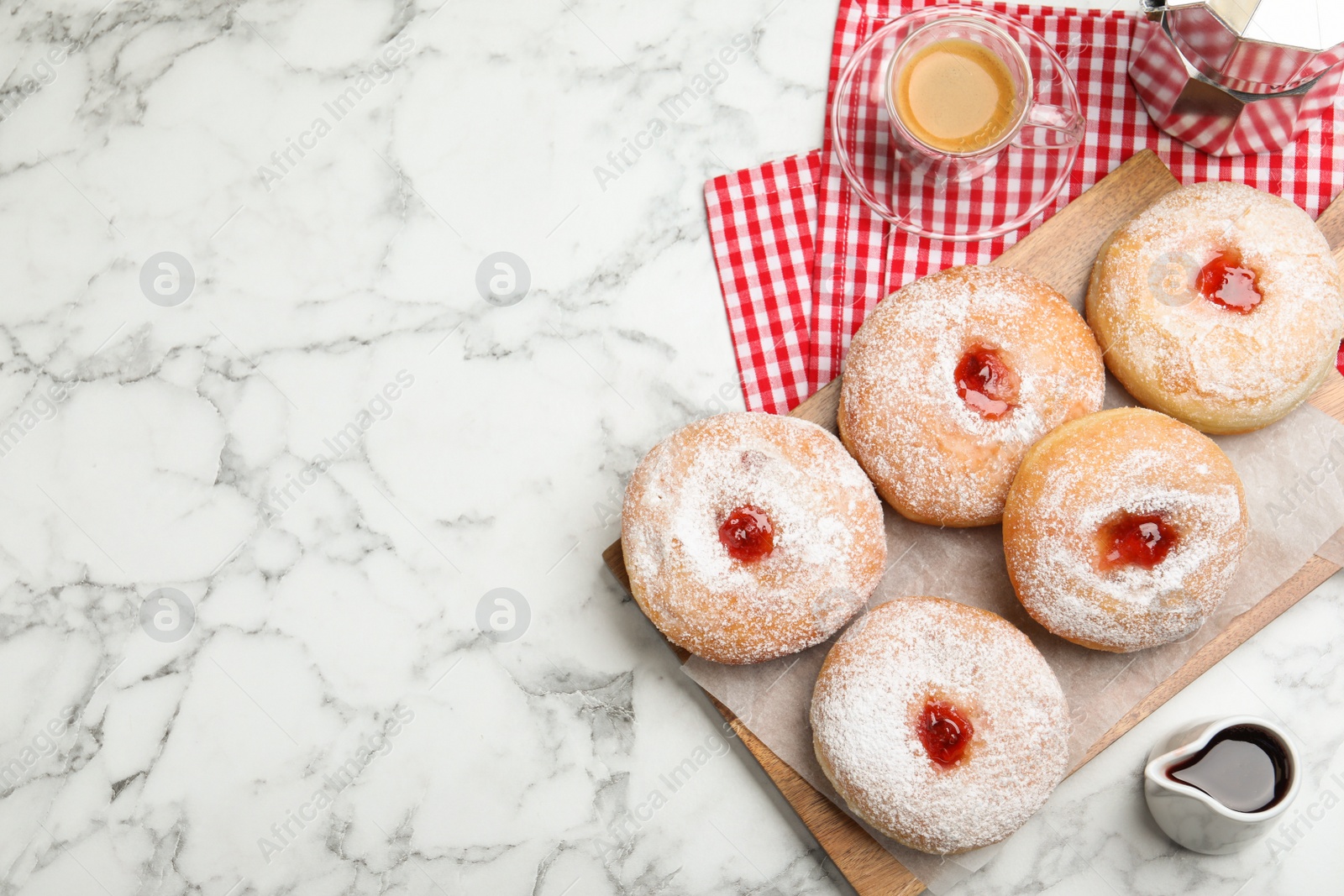 Photo of Delicious jam donuts served with coffee on white marble table, flat lay. Space for text