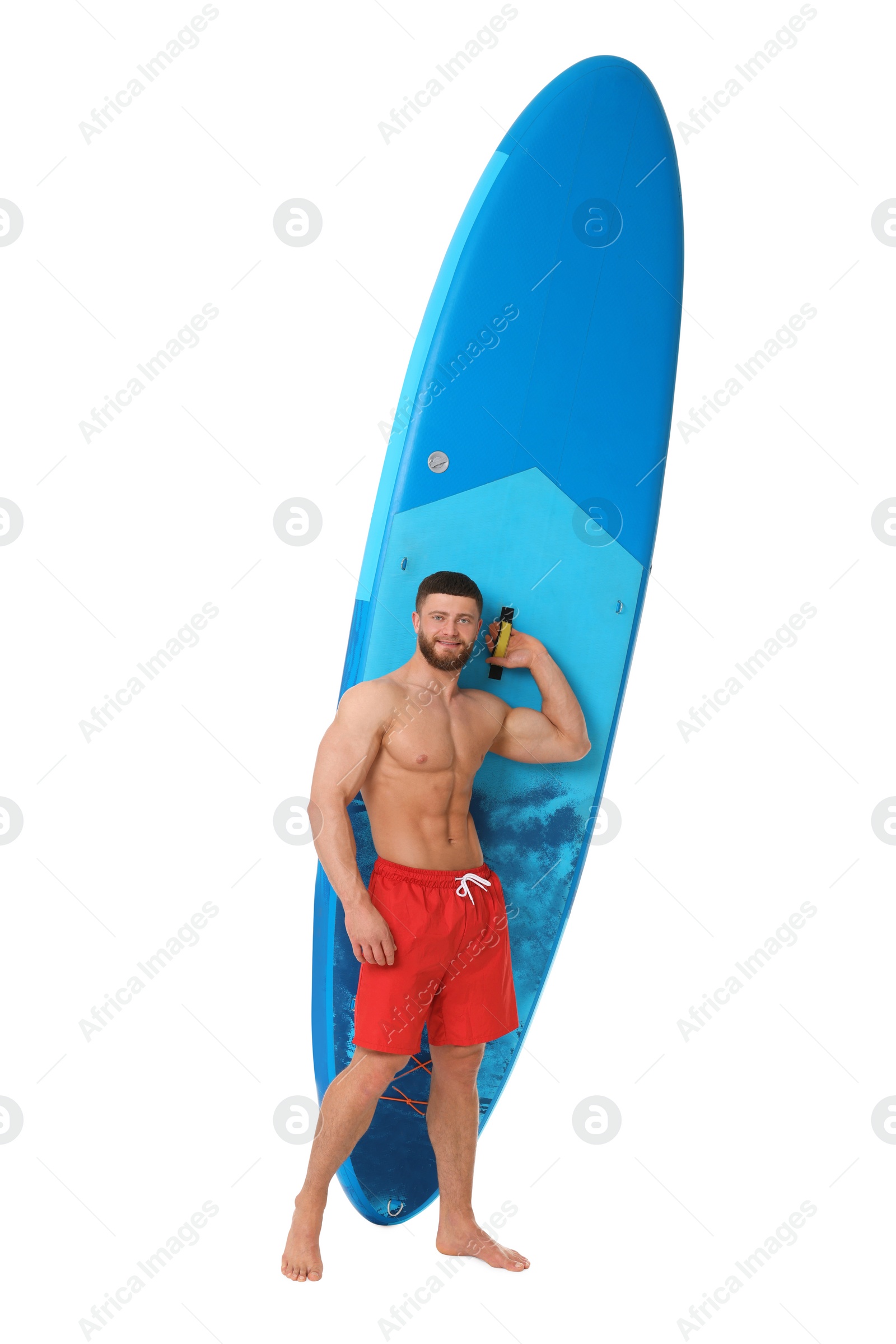 Photo of Handsome man with blue SUP board on white background