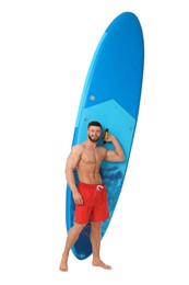 Handsome man with blue SUP board on white background