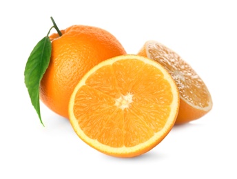 Photo of Cut and whole fresh ripe oranges with green leaf on white background