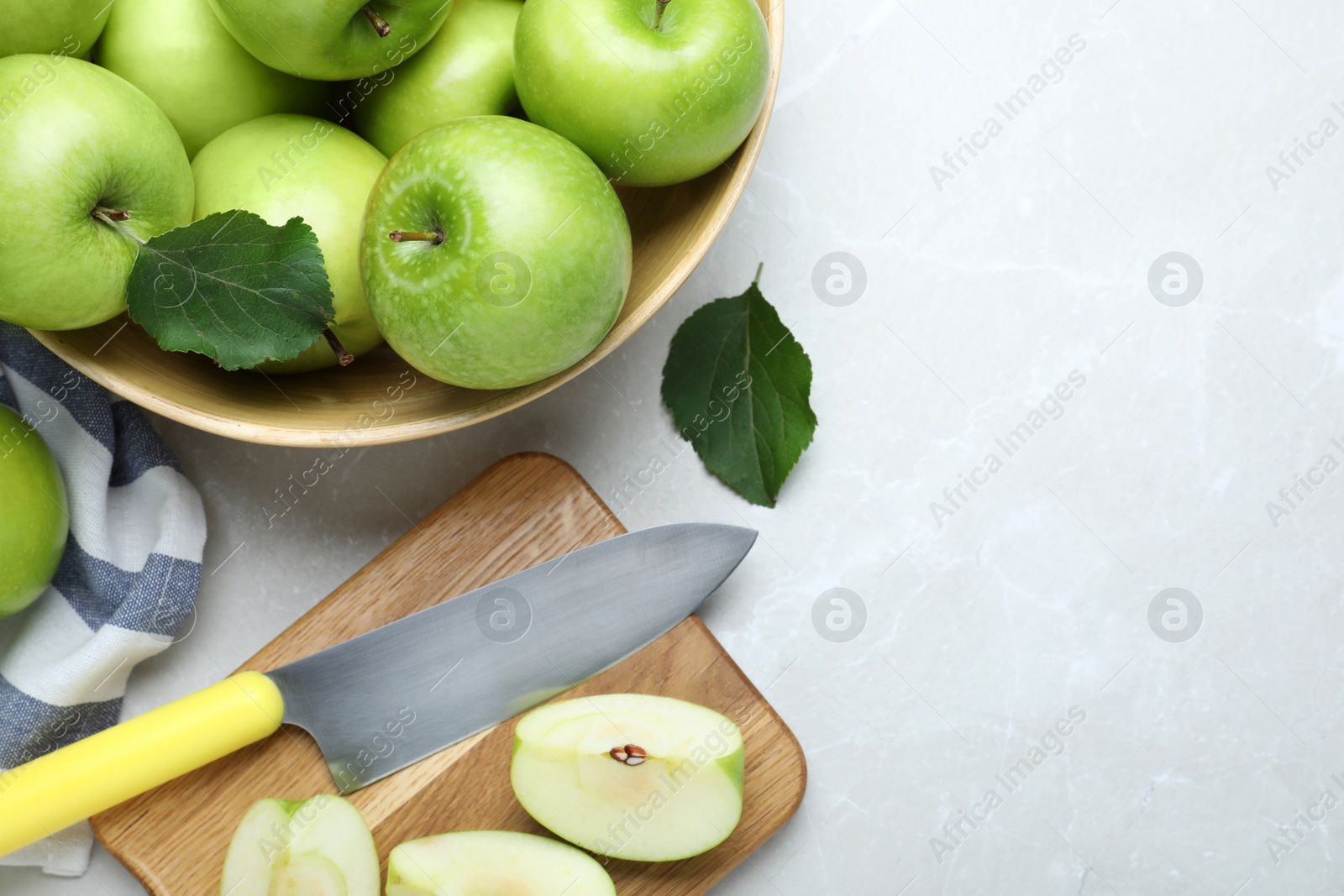 Photo of Flat lay composition with juicy green apples on white table, space for text