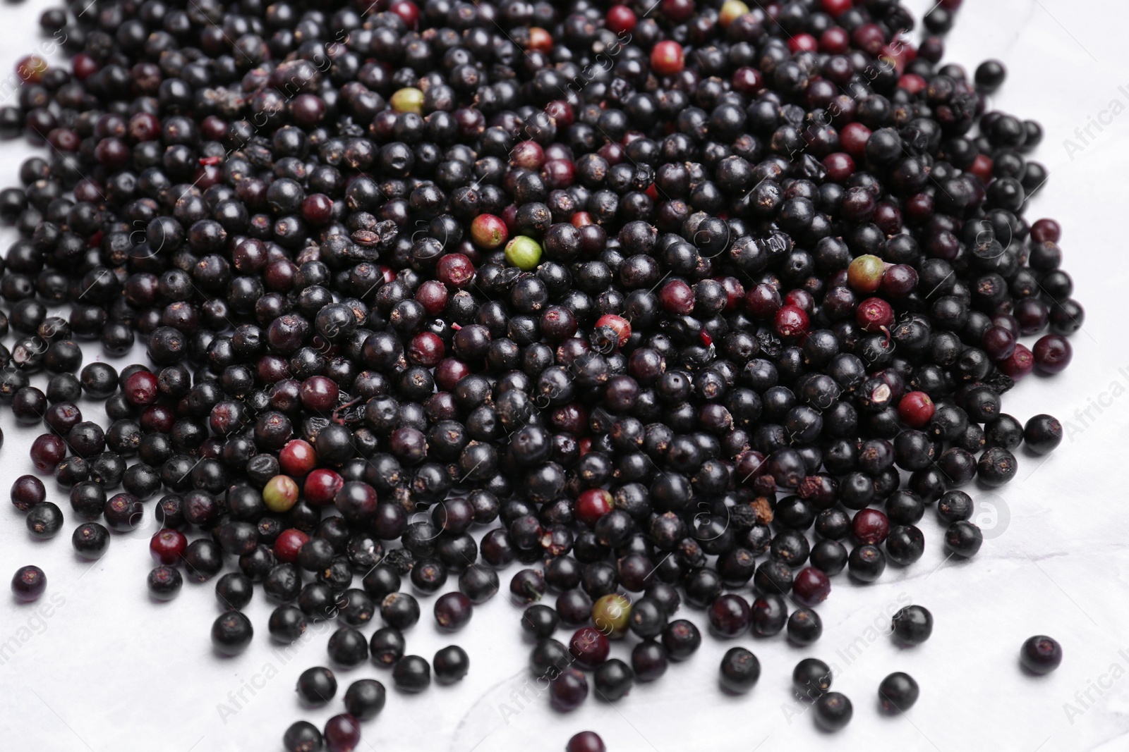 Photo of Pile of tasty elderberries (Sambucus) on table, top view