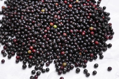 Photo of Pile of tasty elderberries (Sambucus) on table, top view