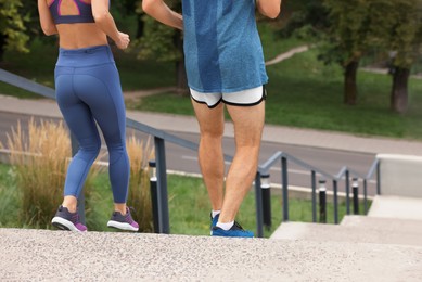 Photo of Healthy lifestyle. Couple running down stairs outdoors, closeup