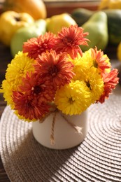 Photo of Beautiful colorful chrysanthemum flowers in vase on table