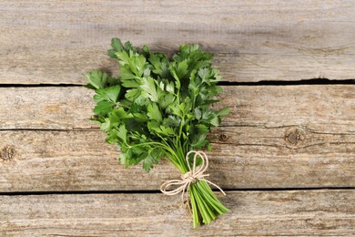 Bunch of fresh green parsley leaves on wooden table, top view