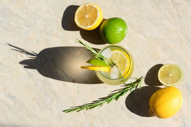 Summer refreshing lemonade and ingredients on light grey table, flat lay. Space for text