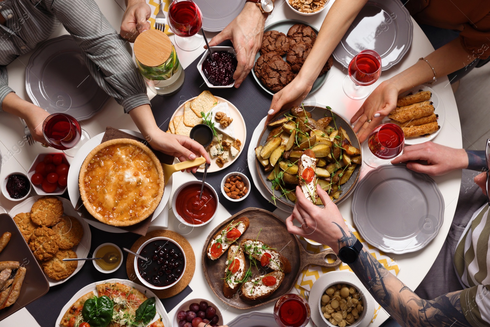 Photo of Group of people having brunch together at table indoors, top view