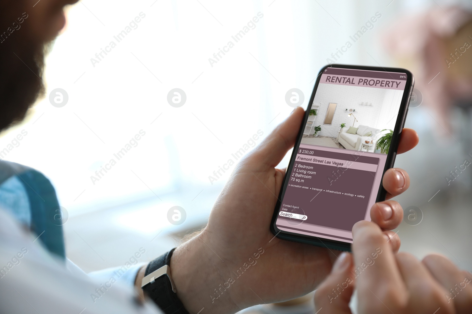 Image of Man searching for apartment on rental property website via smartphone, closeup