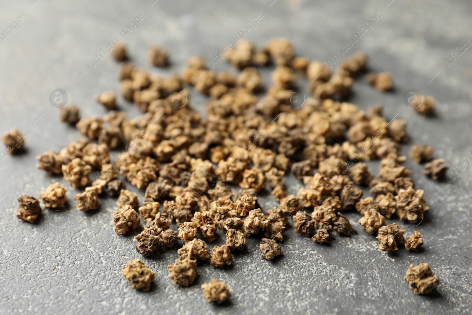 Photo of Raw beet seeds on grey background, closeup. Vegetable planting